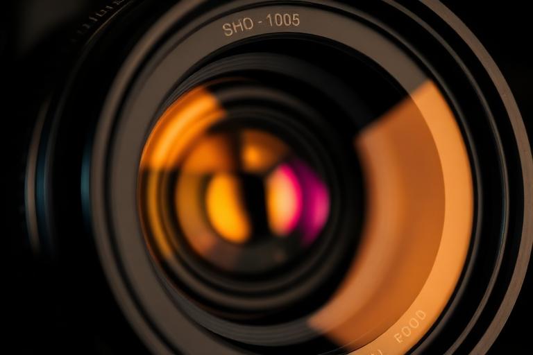 Close-up of a camera lens with natural grain and bokeh