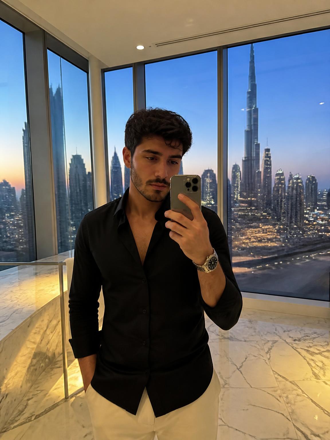 Creator taking a phone selfie in a penthouse with a city skyline at blue hour